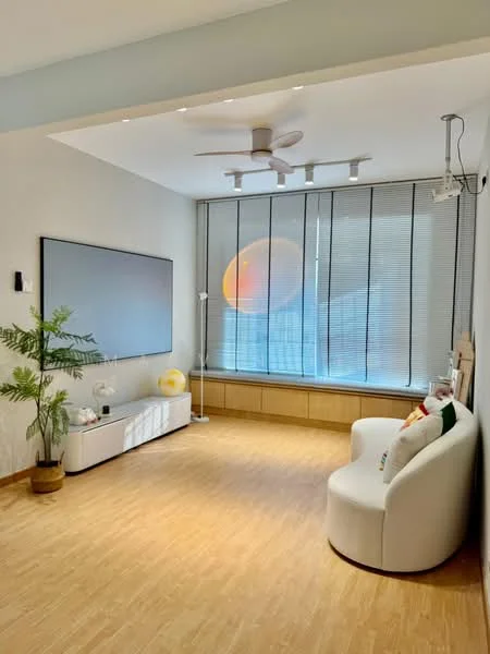 Living features: light wood flooring, white painted walls, ceiling fan with light, recessed LED downlights, large window with blinds, white TV console, green potted plant, round white sofa, decorative cushions, wooden window sill, wall-mounted TV; style: modern; view: city.