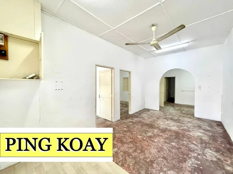 Room features: white painted walls, exposed ceiling with beams, ceiling fan, brown stained flooring, arched doorway, doorway leading to another room, window with no visible treatment, light source from ceiling.