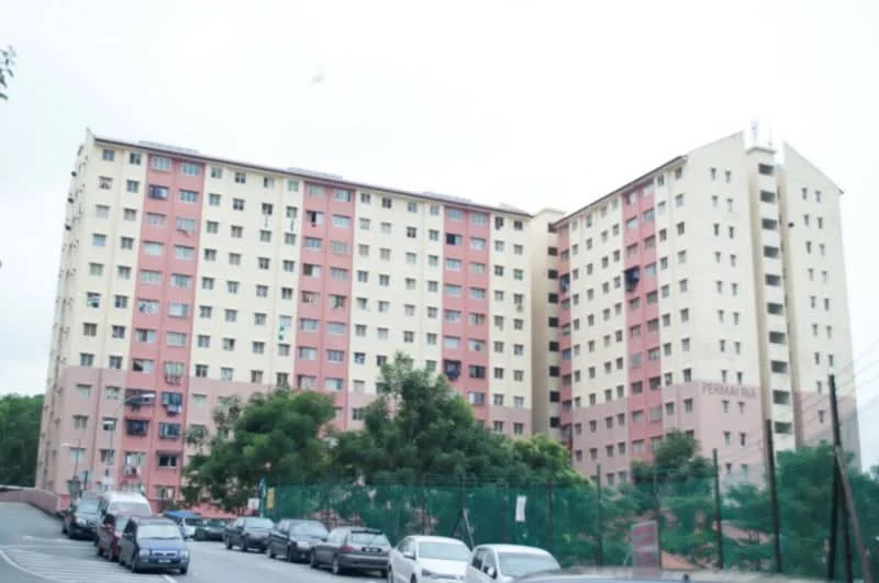 Exterior type: low-rise apartment block; features: pink and cream painted facade, multiple windows, 5-storey building, surrounded by greenery, parking area in front, fenced perimeter; style: modern.