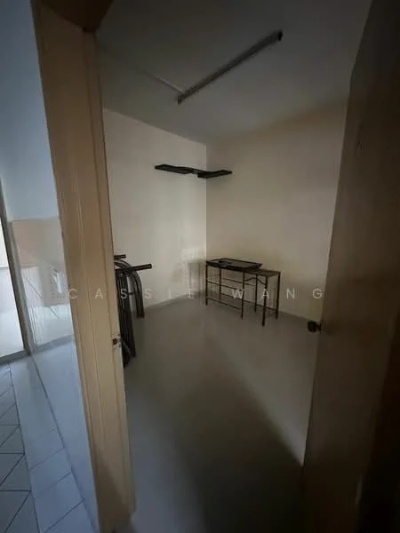Room features: plain white walls, grey vinyl flooring, single light fixture on ceiling, metal shelving unit on wall, small table, doorway leading to another room, no visible windows; style: minimalist.