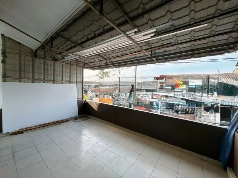 Room features: tile flooring, exposed ceiling with metal roofing, large windows with unobstructed view, white wall, open layout, natural light, unfinished walls, view of surrounding buildings; view: city.