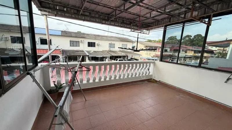 Room features: tiled flooring, white painted walls, metal railing, roof overhang, large windows, clothes drying rack, open space, view of neighboring buildings.