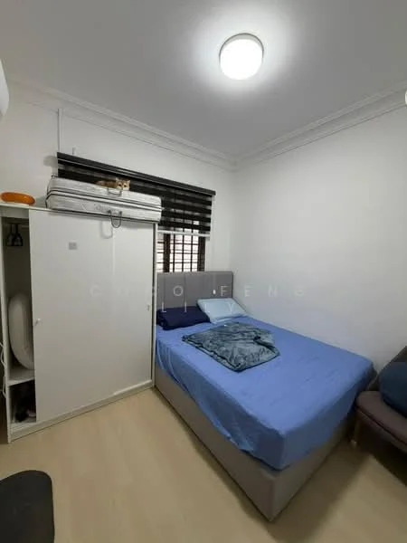 Bedroom features: single bed with blue bedding, upholstered headboard, white painted walls, laminate flooring, built-in wardrobe with sliding doors, blackout window blinds, ceiling light fixture, small bedside table, decorative throw blanket; style: modern.