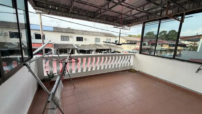 Room features: tiled flooring, white painted walls, metal railing, overhead roof structure, large windows, view of neighboring buildings, clothes drying rack; view: city.
