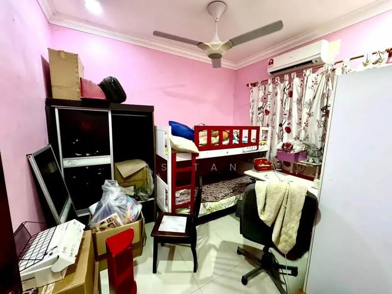 Bedroom features: pink painted walls, white ceiling with crown moulding, 5-blade ceiling fan, floor tiles, bunk bed with red frame, curtains with floral pattern, built-in wardrobe, office chair, small study desk, cardboard boxes, plastic bags, miscellaneous items.