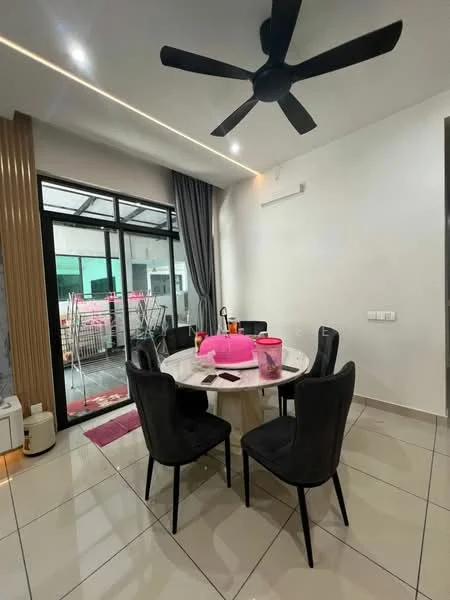 Dining features: round dining table, 6 upholstered dining chairs in black, ceiling fan with 3 blades, white painted walls, grey curtains, tile flooring, glass sliding door, decorative wall paneling, pink decorative item on table; style: modern.