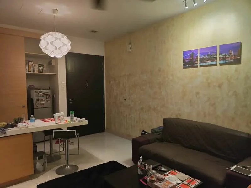 Living features: sofa in dark fabric, coffee table, area rug, wall-mounted TV, decorative wall art with city skyline, white painted walls with textured finish, recessed lighting, ceiling fan, open shelving, dining table with chairs, kitchenette with cabinets, fridge, kitchen countertop; style: modern.