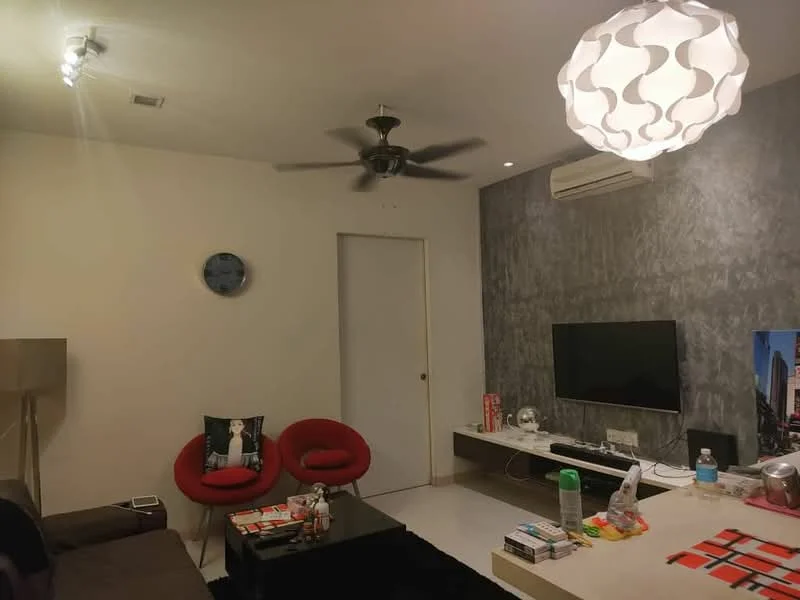 Living features: grey accent wall, white painted walls, 5-blade ceiling fan with light, recessed downlights, pendant lamp, wall-mounted TV, black coffee table, 2 red accent chairs, sofa in dark color, area rug in black, decorative wall clock, magazines on coffee table; style: modern.