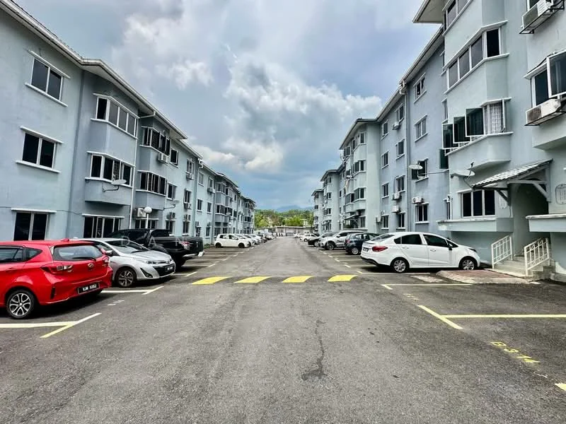 Exterior type: low-rise apartment block; features: grey painted facade, 2-storey building, multiple air conditioning units visible, parking spaces visible, asphalt driveway, marked parking bays, surrounded by greenery; style: modern.