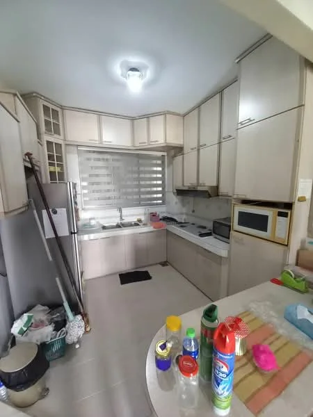 Kitchen features: light wood cabinetry, white countertop, stainless-steel fridge, built-in microwave, freestanding oven, ceramic tile flooring, window with horizontal blinds, sink with faucet, kitchen island with seating, various kitchen appliances, cleaning supplies on counter, open shelving, trash bin; style: modern.
