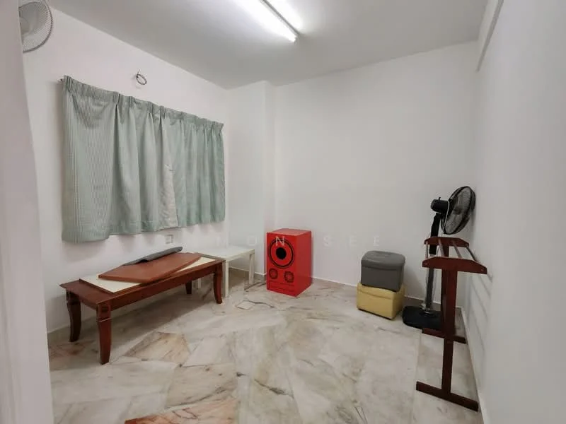 Room features: white painted walls, marble flooring, curtains in light green, wooden table, red storage box, grey ottoman, standing fan, wooden rack; style: minimalist.