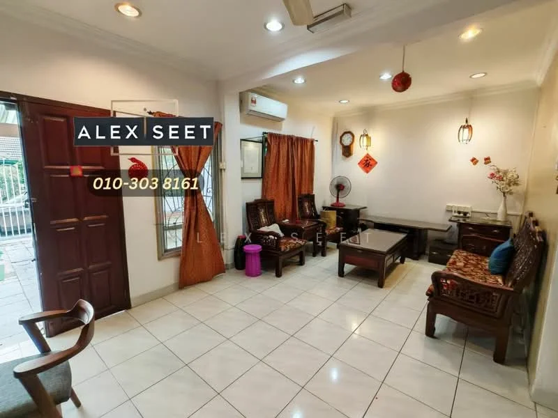 Living features: white painted walls, ceramic tile flooring, recessed downlights, 5-blade ceiling fan, wooden coffee table, 2-seater wooden sofa with cushions, armchair, wall-mounted decorative items, curtains, window with grille, decorative wall art, floor fan; style: traditional.