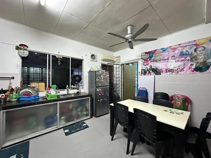 Kitchen features: stainless-steel fridge, kitchen cabinets with glass doors, countertop with storage underneath, sink with faucet, ceramic tile flooring, ceiling fan, dining table with black chairs, decorative wall banner, window with metal grilles, plastic storage bins, various kitchen utensils and appliances.