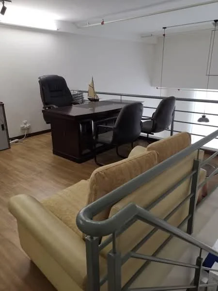 Study features: wooden flooring, cream fabric sofa, wooden desk, black office chair, two grey office chairs, decorative sailboat model, metal railing, recessed ceiling lights, large windows with blinds; style: modern.