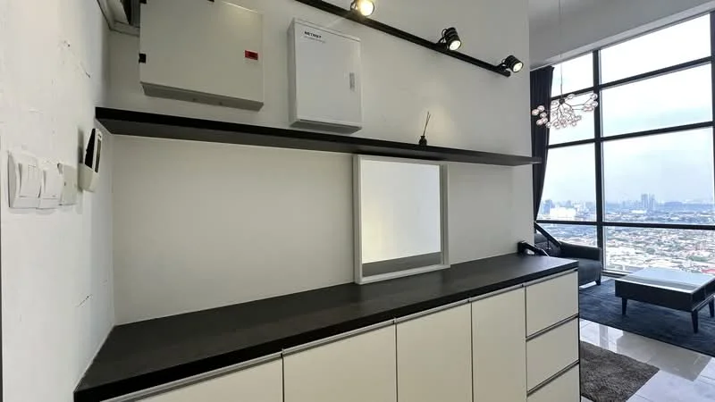 Room features: white painted walls, black countertop, built-in cabinetry with multiple drawers, mirror, shelf above countertop, track lighting, electrical panel, city skyline view through large windows; style: modern; view: city.