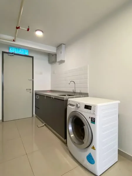 Laundry features: white washing machine, grey cabinetry, white tiled backsplash, single-bowl stainless-steel sink, chrome faucet, light-colored wall, cream floor tiles, recessed lighting, door with handle, exit sign above door; style: modern.