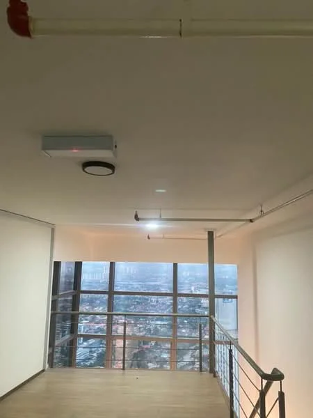 Room features: white painted walls, laminate flooring, ceiling-mounted air conditioning unit, recessed ceiling lights, metal railing, large floor-to-ceiling windows, city view, exposed ceiling pipes; style: modern; view: city.
