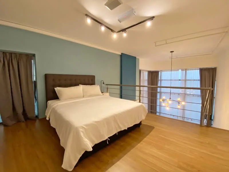 Bedroom features: king-size bed, upholstered headboard, white bedding, wood flooring, blue accent wall, recessed downlights, hanging pendant light, floor-to-ceiling windows, curtains, metal railing; style: modern; view: city.