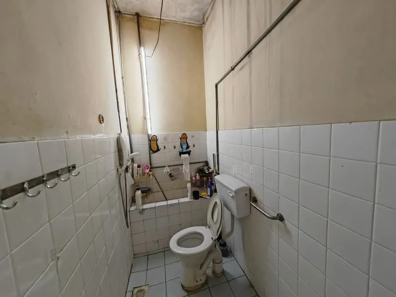 Bathroom features: white tiled walls, white tiled flooring, toilet, sink, wall-mounted mirror, exposed plumbing, hooks on wall, natural light from window.