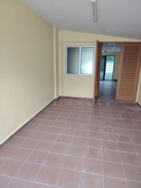 Room features: cream painted walls, brown tiled flooring, sliding glass window, louvered doors, natural light from window, open layout, no visible furniture, neutral color scheme.