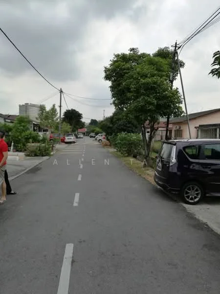 Exterior features: residential street, asphalt road, trees lining the street, parked cars, overcast sky, utility poles, sidewalks.