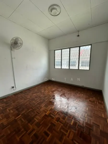 Room features: parquet wood flooring, white painted walls, ceiling fan, window with metal grille, natural light from window.