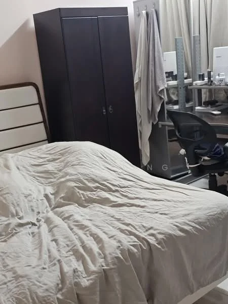 Bedroom features: king-size bed with beige bedding, wooden headboard, dark wooden wardrobe, study desk with chair, computer monitor, curtains, light-colored walls, carpeted flooring.