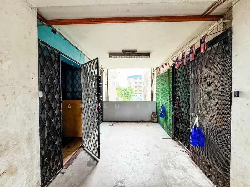 Room features: concrete flooring, exposed concrete walls, metal security doors, overhead fluorescent lighting, open space layout, windows with view to outside, hanging decorative items, unfinished walls; style: industrial; view: courtyard.