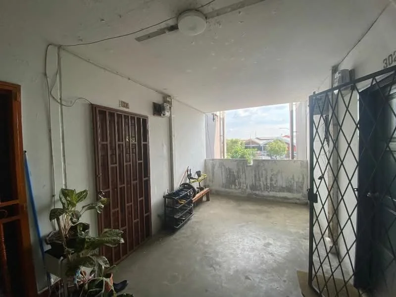 Room features: concrete flooring, white painted walls, ceiling light fixture, security grille door, wooden door, small bench, potted plant, window with view, exposed ceiling, natural light from window; style: minimalist; view: garden.