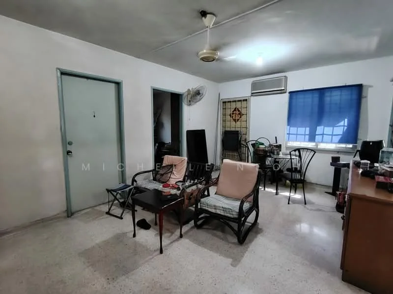 Living features: white painted walls, ceiling fan, window with blue curtain, light-colored flooring, two armchairs, coffee table, side table, wall-mounted air conditioning unit, decorative wall panel, open doorway to adjacent room.