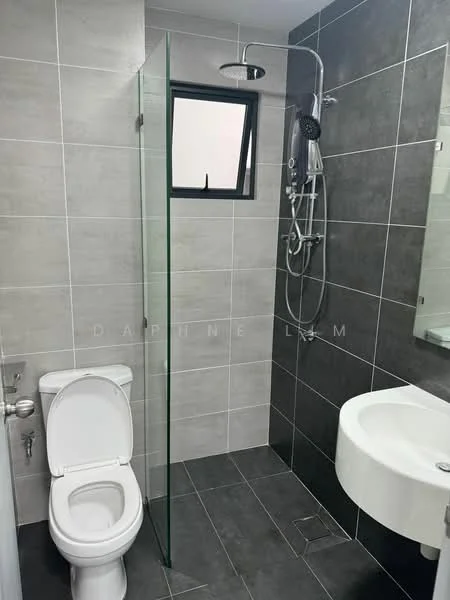 Bathroom features: grey tiled walls, white ceramic toilet, glass shower enclosure, chrome shower head, handheld shower, wall-mounted faucet, white sink, mirror above sink, dark tiled flooring; style: modern.
