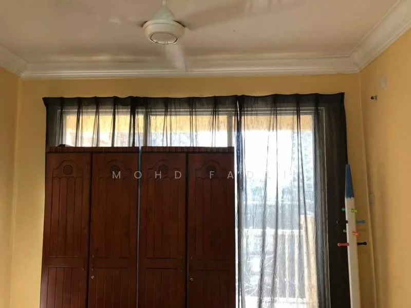 Room features: yellow painted walls, ceiling with crown moulding, floor-to-ceiling windows, black sheer curtains, wooden wardrobe, ceiling fan.