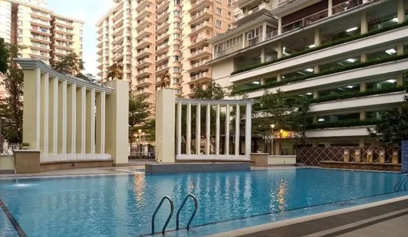 Exterior type: high-rise condominium; features: infinity pool, pool deck with loungers, surrounded by landscaped gardens, tall residential buildings in background, decorative columns, water feature, paved walkway, multiple levels of parking visible; style: modern.