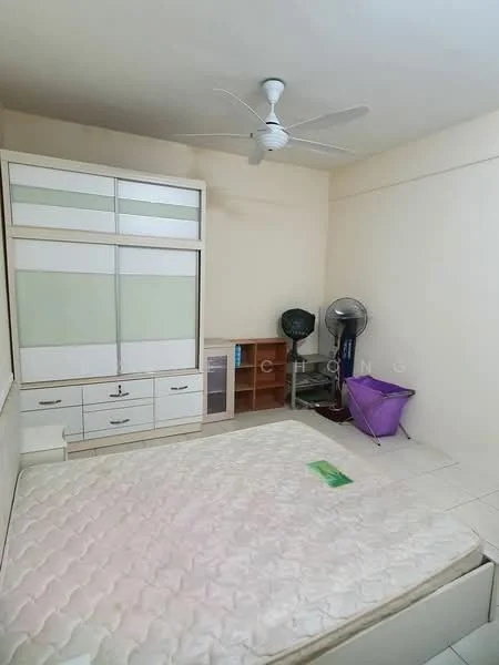 Bedroom features: queen-size bed, white built-in wardrobe with sliding doors, wooden shelving unit, ceiling fan, tile flooring, light beige painted walls, window with no visible treatment, standing fan, purple storage basket.