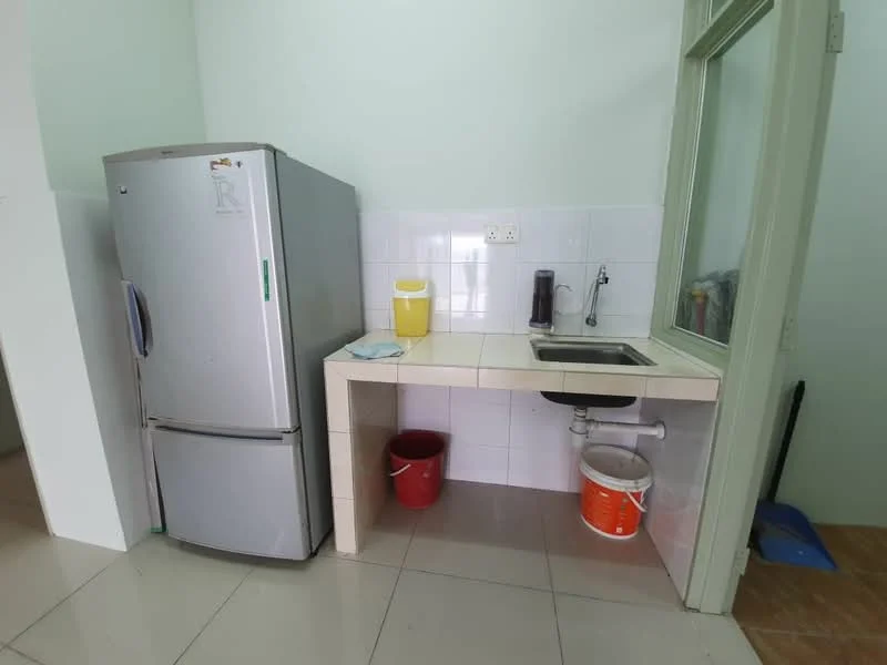 Kitchen features: stainless-steel fridge, single-bowl stainless-steel sink, white tiled backsplash, light-colored countertop, white painted walls, ceramic tile flooring, window with green frame, plastic bucket, red bucket, coffee maker.