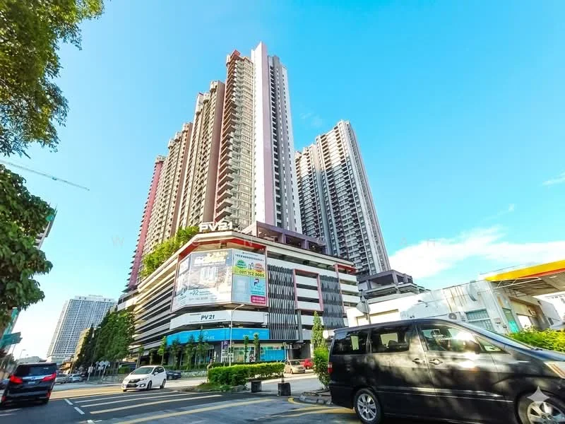 Exterior type: high-rise condominium; features: glass curtain wall, white painted facade, recessed balconies, multiple storeys, commercial space at ground level, surrounded by urban landscape, visible signage, parking area in front; style: modern.