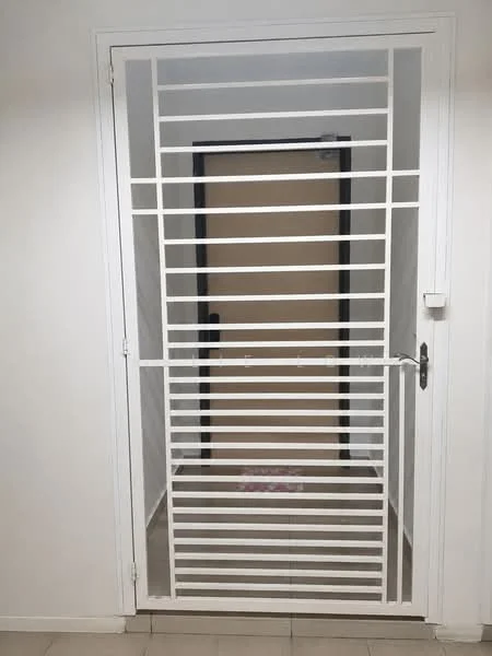 Room features: white security grille door, plain wooden door behind grille, neutral wall colour, tile flooring, door handle, door lock, minimalist design; style: modern.