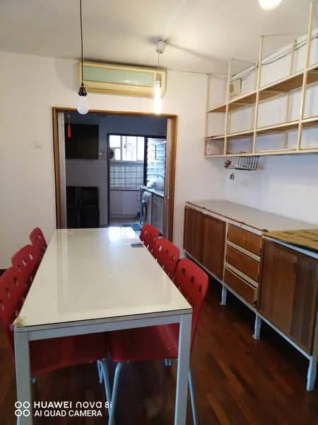 Dining features: white dining table, 6 red dining chairs, wooden cabinetry, open shelving, wooden flooring, wall-mounted air conditioning unit, light fixture with exposed bulb, doorway leading to kitchen; style: modern. Kitchen features: kitchen cabinetry, window, countertop, sink, appliances visible in background.