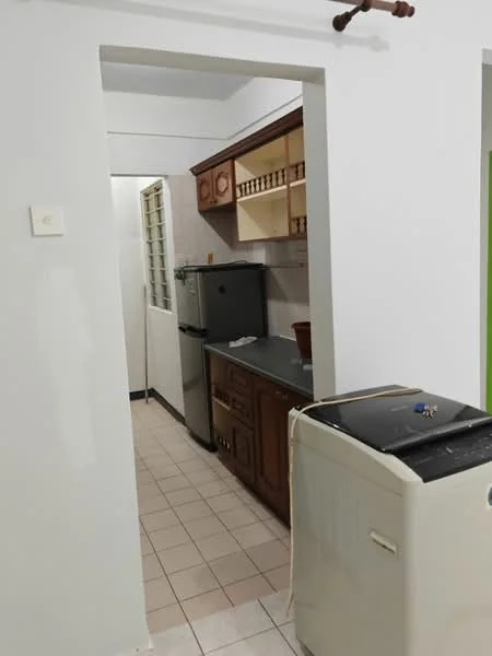 Kitchen features: brown wooden cabinetry, stainless-steel fridge, built-in countertop, ceramic tile flooring, white painted walls, window for natural light, washing machine, sink, kitchen utensils on shelf.