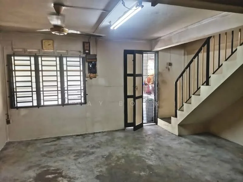 Room features: concrete flooring, white painted walls, exposed ceiling, ceiling fan, window with metal grille, staircase leading to upper floor, door leading outside, clock on wall; style: minimalist.