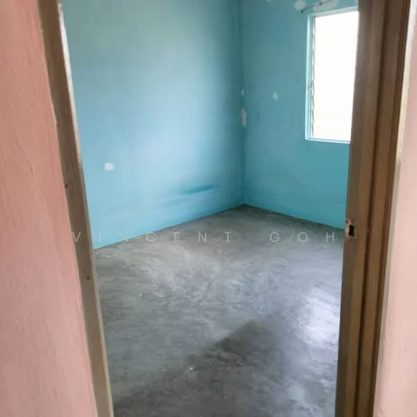 Room features: blue painted walls, concrete flooring, single window, plain ceiling, no visible fixtures or furniture.