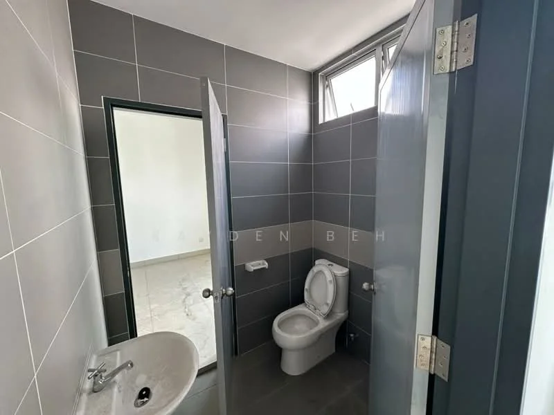 Bathroom features: grey tiled walls, white ceramic toilet, white sink with pedestal, mirror above sink, window for natural light, grey tiled flooring, chrome faucet, toilet paper holder, soap dish, light fixture; style: modern.
