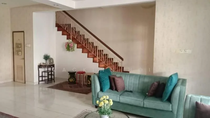 Living features: green fabric sofa, decorative cushions in teal, coffee table, area rug, white painted walls, tile flooring, staircase with wooden steps, wall-mounted decor, potted plants, wall sconce lighting; style: modern.
