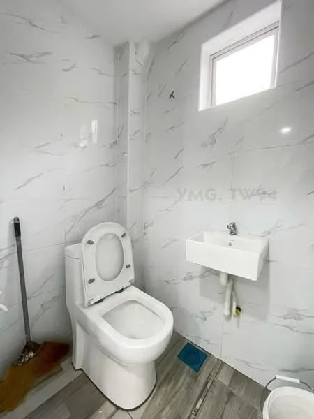 Bathroom features: white toilet, wall-mounted sink, grey ceramic tile flooring, white marble wall tiles, small window, cleaning broom, drainage pipe, toilet paper holder; style: modern.