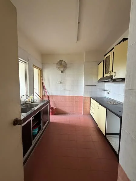 Kitchen features: single-bowl stainless-steel sink, chrome faucet, black countertop, yellow cabinetry, white tiled walls, red tiled flooring, window with view to outside, exhaust fan, built-in stove, open shelving, cleaning supplies visible.