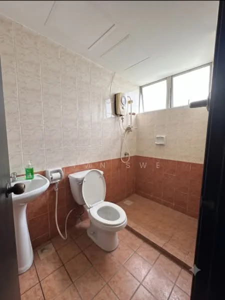 Bathroom features: white tiled walls, brown tiled flooring, shower area with glass partition, toilet, sink with pedestal, water heater, window for natural light, towel rack.