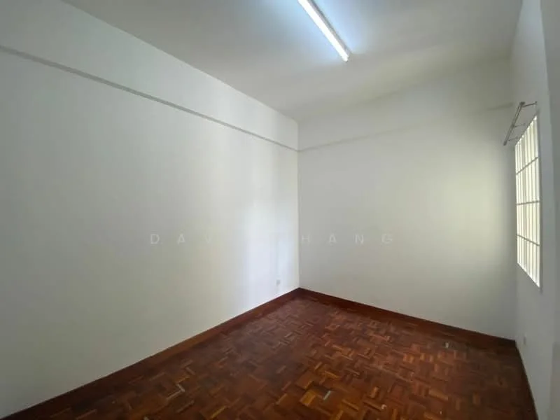 Room features: white painted walls, parquet wood flooring, single window with horizontal bars, ceiling light fixture, no visible furniture.