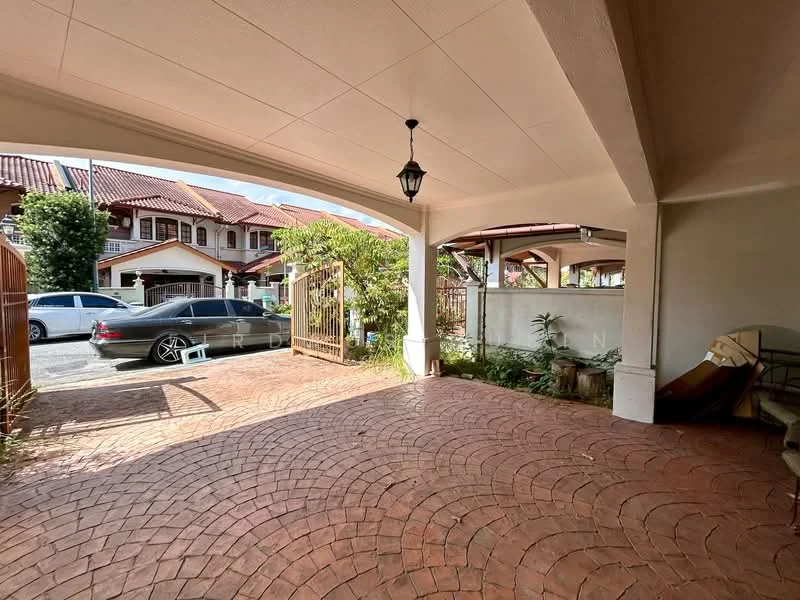 Exterior type: linked terrace house; features: paved driveway with interlocking pavers, covered car porch, lantern-style light fixture, manicured landscaping with plants, fenced perimeter, adjacent to residential street, visible parked car, front garden area; style: modern.