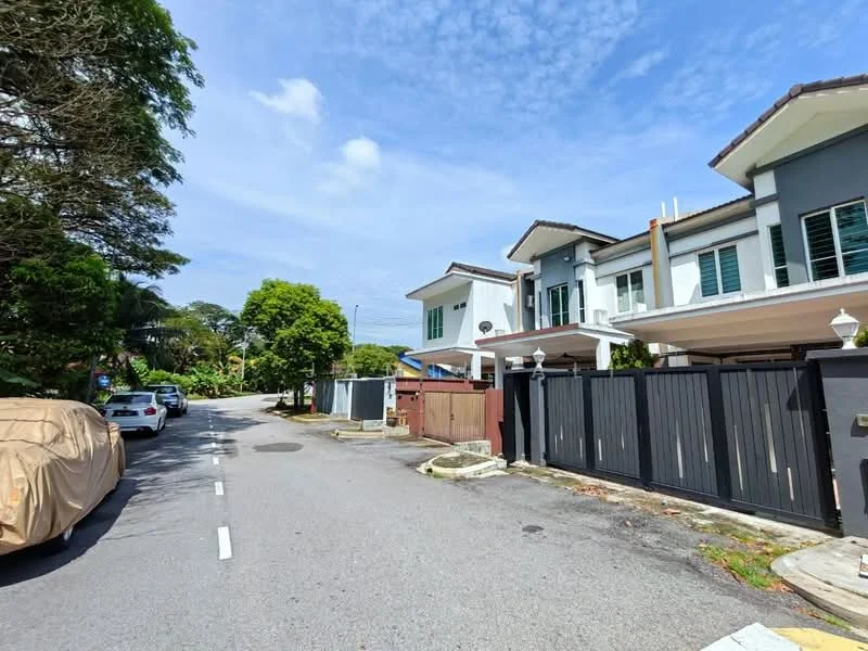 Exterior type: semi-detached house; features: grey painted facade, white trim, gabled roof, two-storey structure, manicured lawn, paved driveway, black wrought iron gate, surrounded by greenery, adjacent to quiet residential street; style: modern.