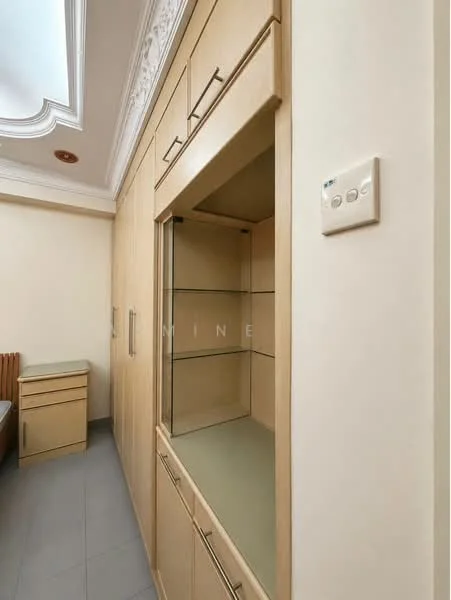 Room features: built-in cabinetry with light wood finish, glass display shelves, flat-panel cabinet doors, countertop surface, recessed ceiling with decorative moulding, grey tile flooring, light switch on wall; style: modern.